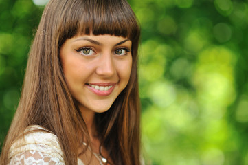 Outdoors portrait of a beautiful girl face over nature backgroun