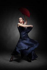 young woman dancing flamenco on black - obrazy, fototapety, plakaty