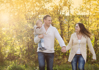 Family relaxing together in golden autumn nature