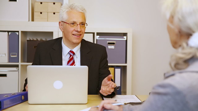 Customer talking to businessman in office