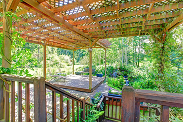 Backyard farm deck with attached open pergola