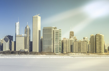 Downtown Chicago winter view with frozen lake and sunshine rays