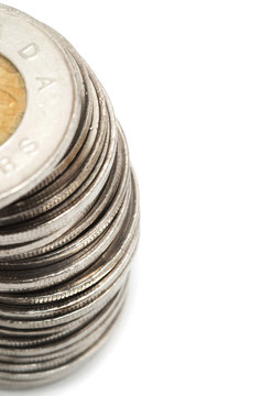 Canadian Dollar Coins Stacked On White Background