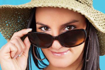 Woman looking over sunglasses