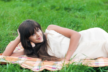 Teenager girl lying on the grass