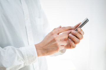 Close-up image of a man using a mobile smartphone - 61009058