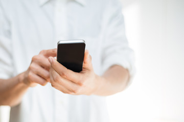 Close-up image of a man using a mobile smartphone - 61009061