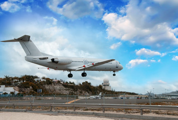 Fototapeta na wymiar Airplane landing in St. Maarten Island, Dutch Antilles