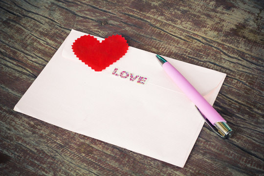 Envelope and pen with heart