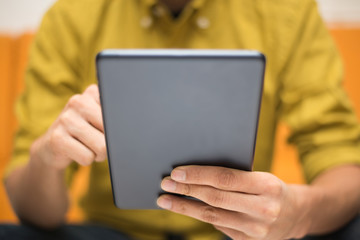 Close-up image of a man using a digital tablet - 61013880