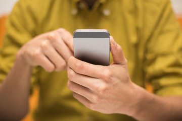 Close-up image of a man using a digital smartphone - 61013884