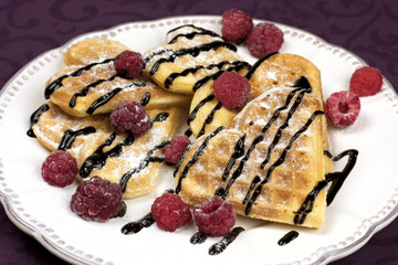 Heart shaped waffles with raspberries