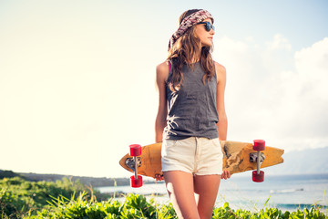 Beautiful young woman with a skateboard