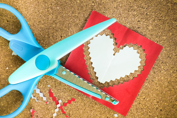 Cutting the heart shaped paper