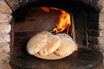 Fresh bread in front of the oven at the morning