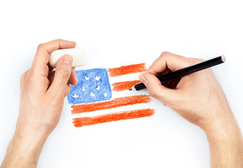 Man's hands with pencil draws flag of USA on white