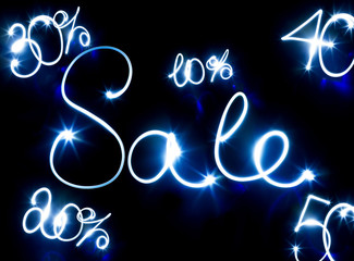 Glowing inscription SALE on a black