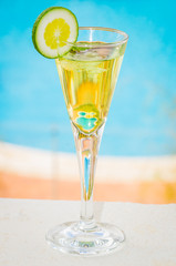 yellow cocktail with a slice of lime