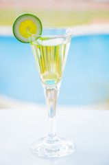 yellow cocktail with a slice of lime