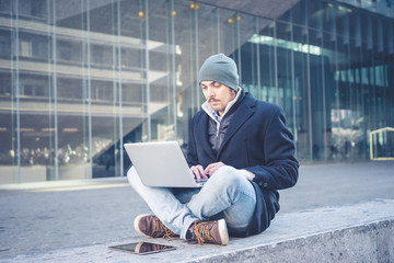 multitasking man using tablet, laptop and cellhpone