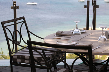tablecloth, iron chairs and sea view, Greece.