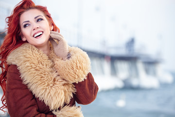 Attractive red hair woman in wintertime outdoor
