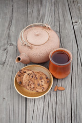 Chocolate chip cookies with cup of tea and china kettle