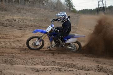 Rider on the motorcycle accelerated along a sandy the track