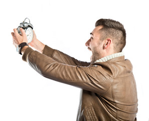 Young businessman holding an antique clock over white background