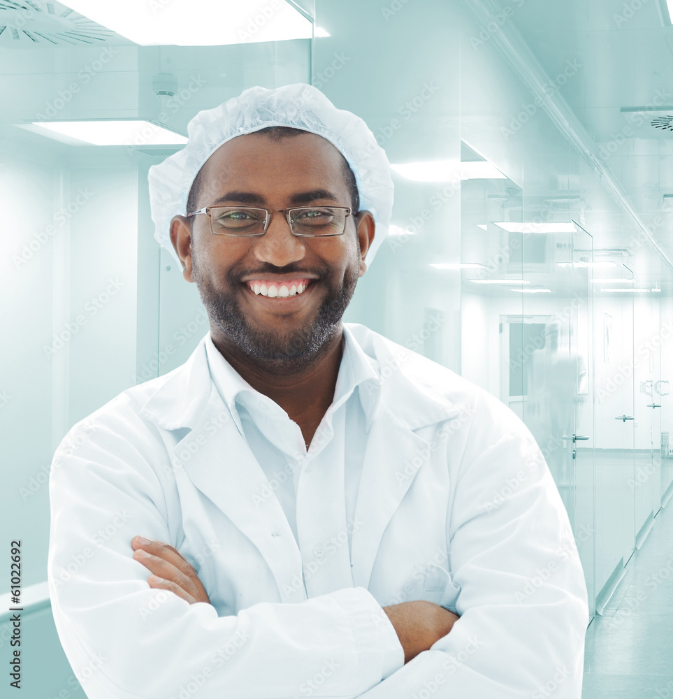 Wall mural Working people with white uniforms in modern facility