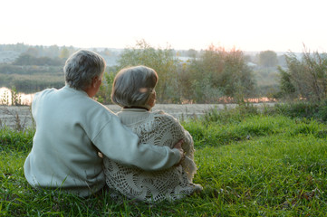 Elderly couple sitting in nature