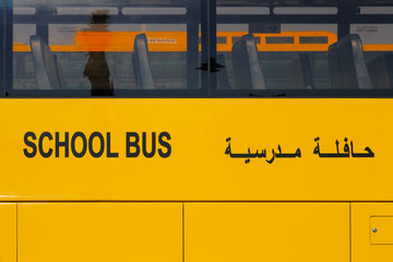 Fototapeta premium UAE, Middle East: A close-up view of a yellow Arabic school bus