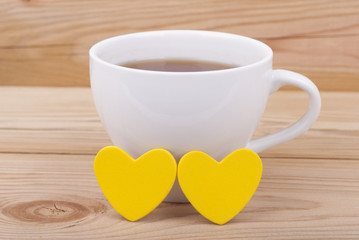 Cup of coffee and two hearts.