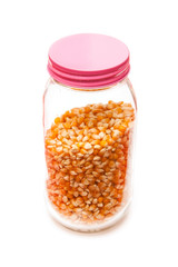 Jar of popcorn isolated on a white studio background.