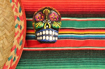 cinco de mayo Mexican blanket sombrero poncho serape stripe background candy skull sombrero fiesta stock photo photograph image