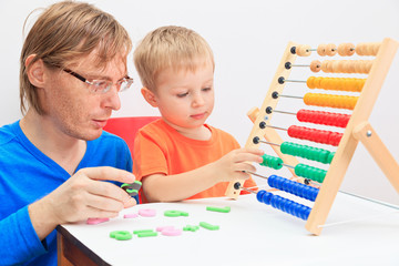 father and son playing with abacus
