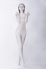 Fototapeta premium Fantasy. Surreal Bodypainting. Woman Colored White. Creative Art