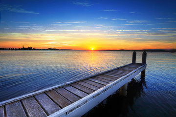 Setting sun behind the boat jetty, Lake Maquarie