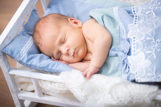 newborn baby  in a small bed