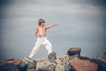 Obraz premium Young boy training karate