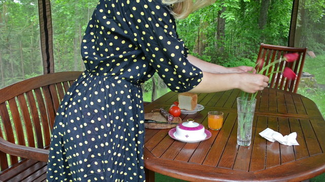 Woman in spotted dress dap flowers. prepare sandwich breakfast