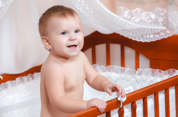 little baby smiling in bed