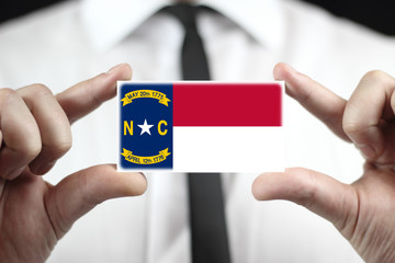 Businessman holding North Carolina State Flag