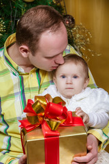 Fototapeta na wymiar Happy father and child near Christmas fir-tree