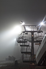 foggy lights of ski lift at night