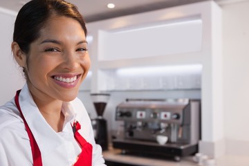 Pretty barista smiling at camera