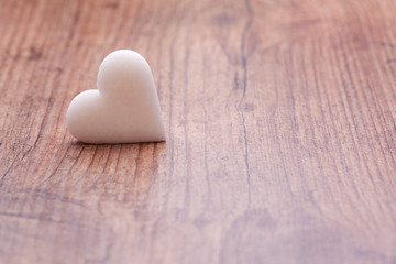 withe one heart on wooden background