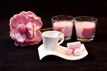 Pink marshmallow, rose and candles.