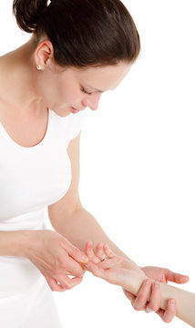 Massage therapist performing hand massage.