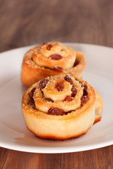 Naklejka na ściany i meble Delicious swirl buns with raisins and brown sugar